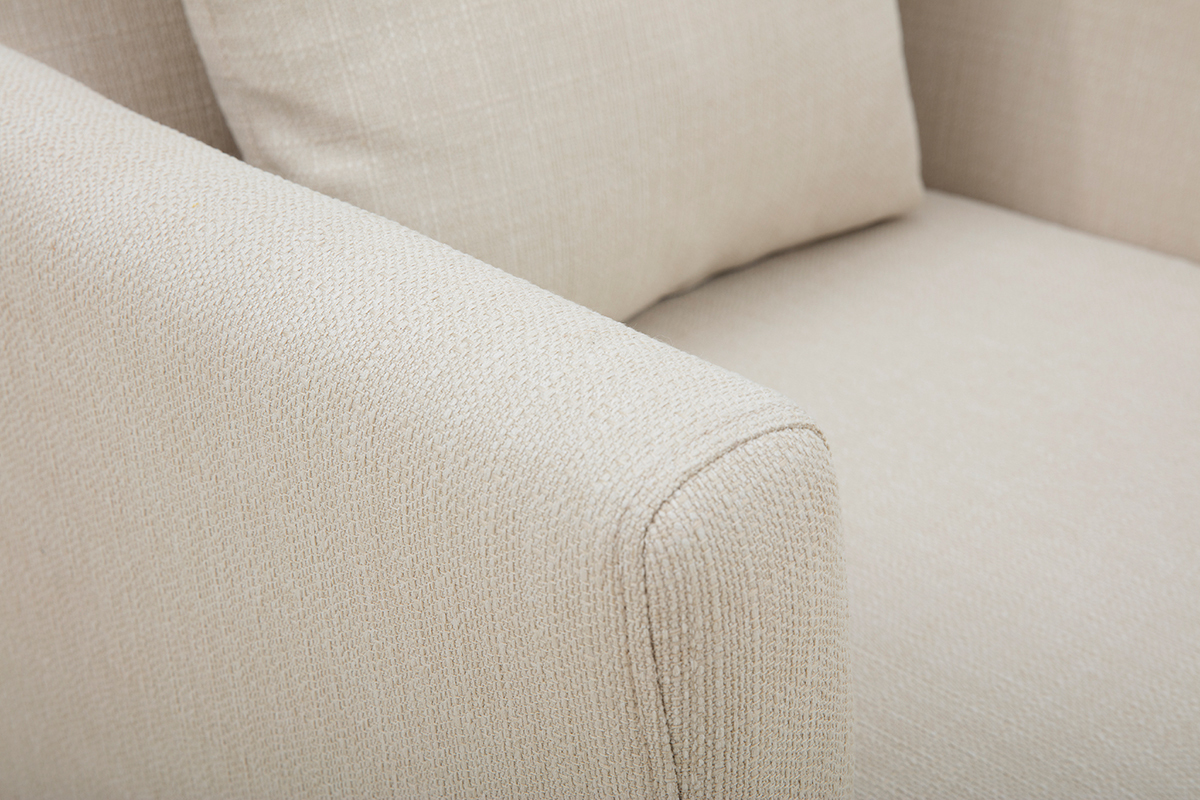 D�tail du fauteuil scandinave d�houssable en tissu beige, montrant l'accoudoir et le coussin.